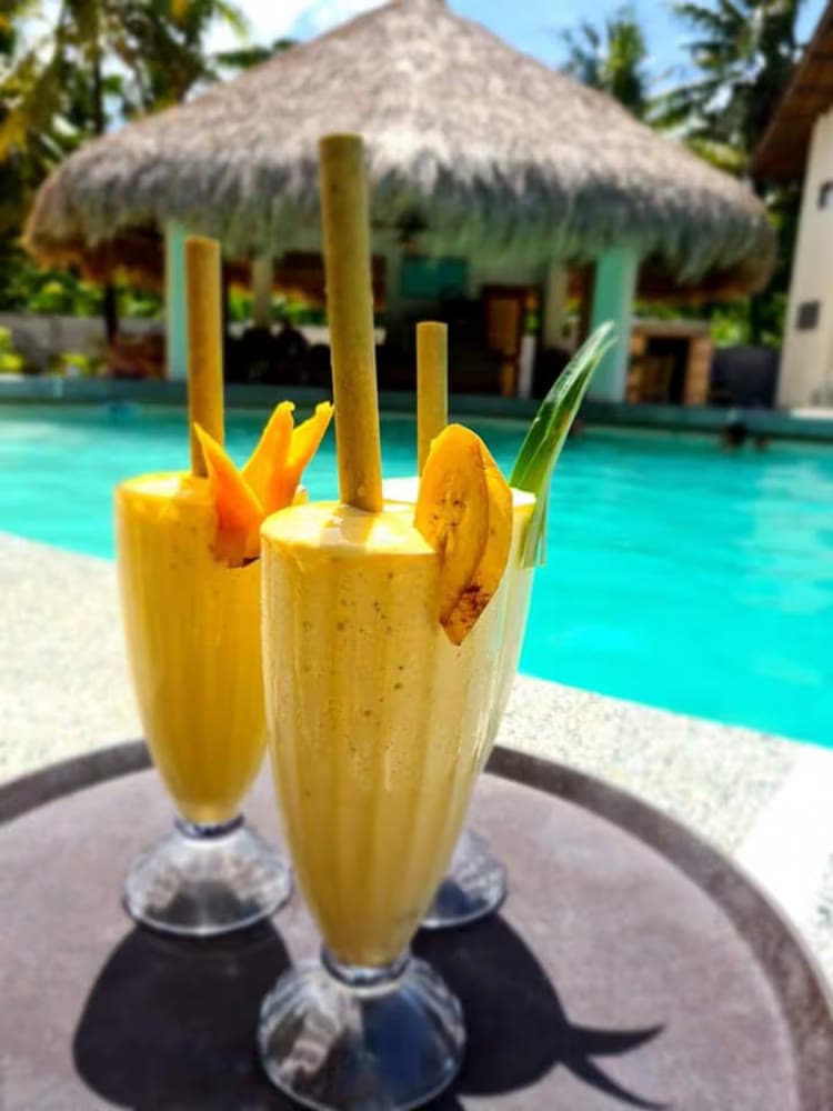 Tropical cocktails garnished with fresh fruit at the Ohana Resort Siargao bar