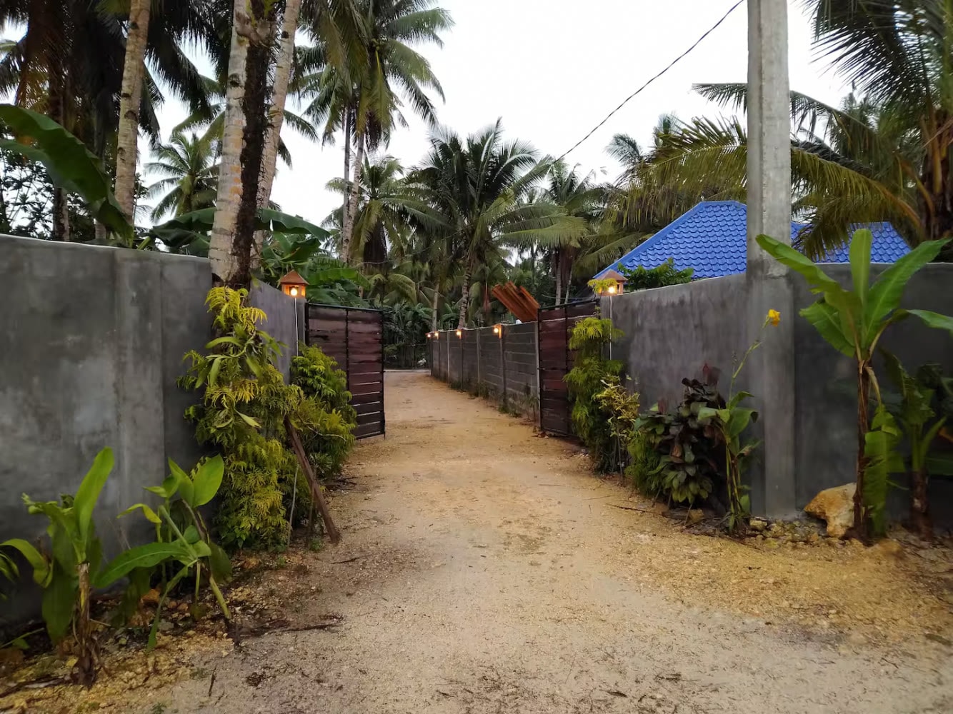 The warm, palm-framed entrance to Ohana Resort Siargao in General Luna